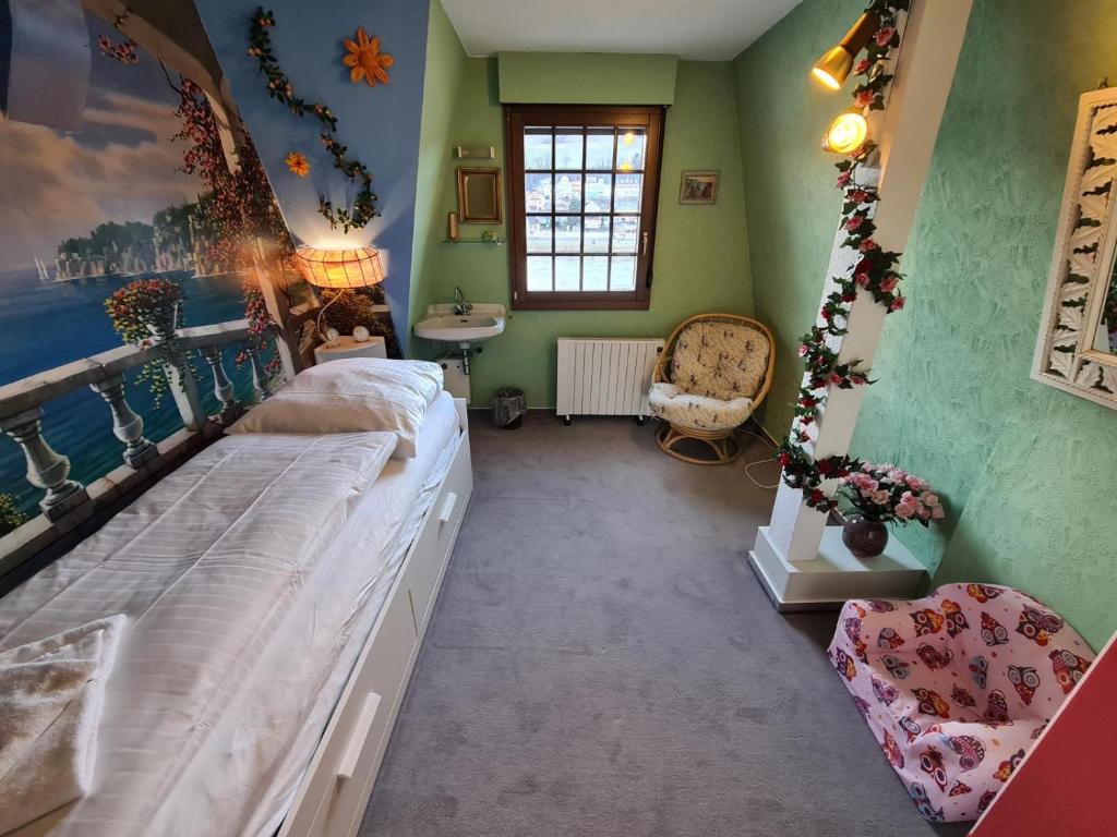 a bedroom with a bed and a sink in it at FerienSchlösschen Zell in Zell an der Mosel