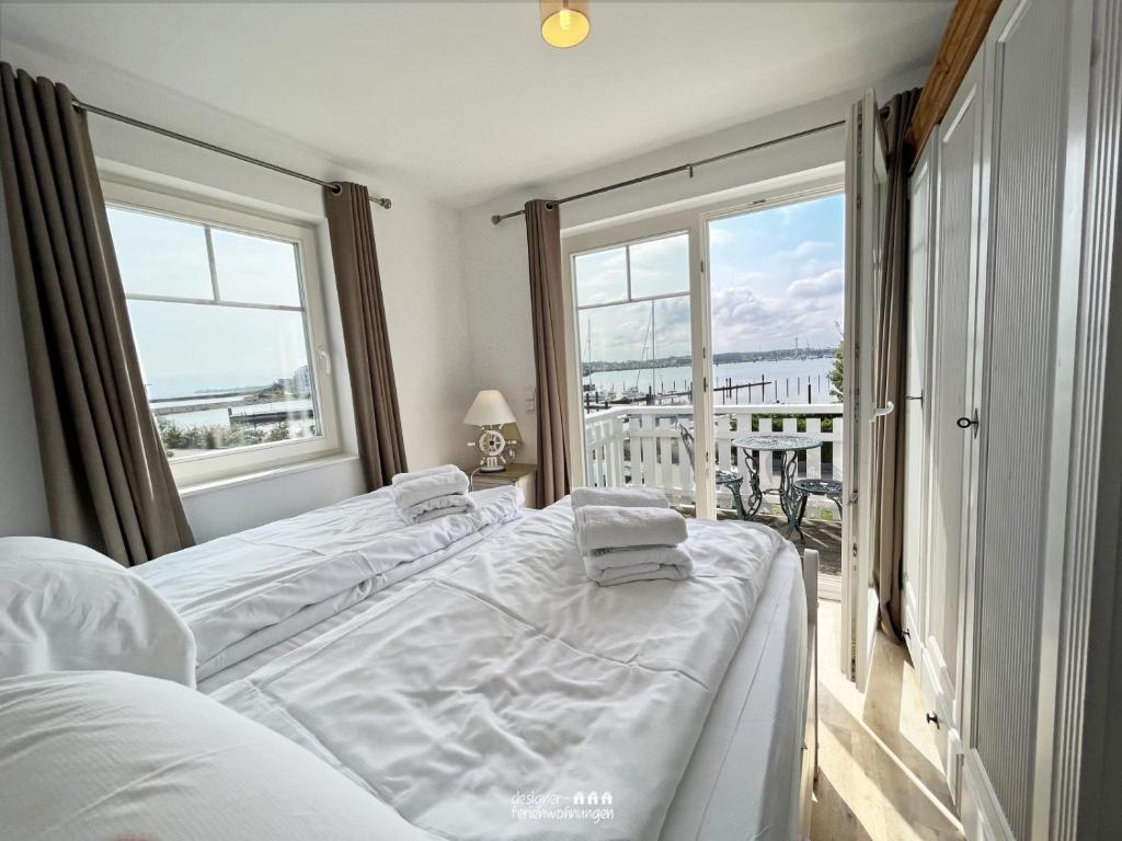 a bedroom with a bed and a large window at The Sea Room in Olpenitz