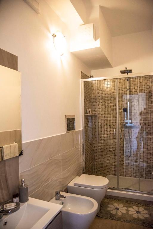 a bathroom with a toilet and a sink and a shower at Blu Mare Lampedusa Bed And Breakfast in Lampedusa