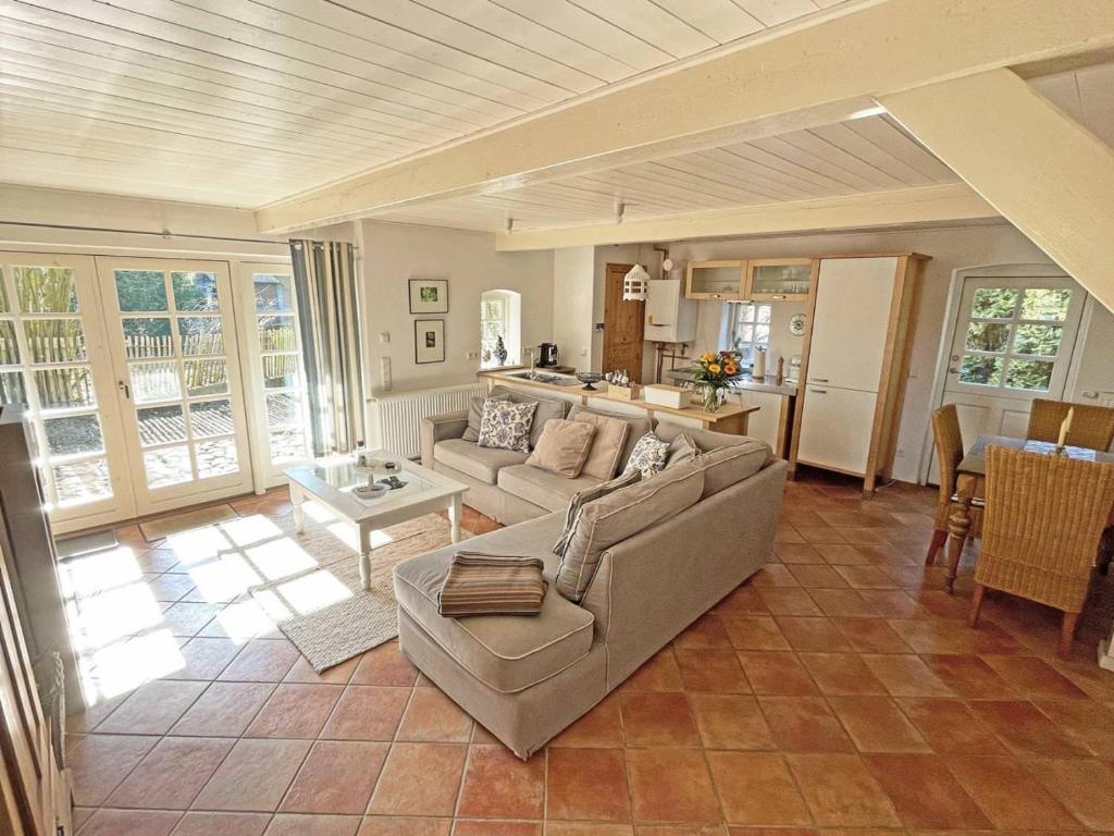 a living room with a couch and a table at Lille Skov in Rabenkirchen