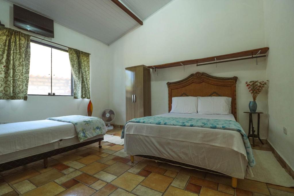 a bedroom with a large bed and a window at Vyzuh in Vale do Capao