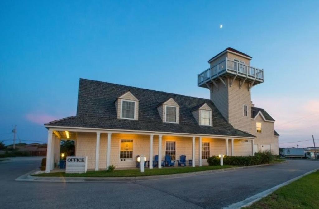 a large white building with a clock on top at Hatteras Island Inn in Buxton