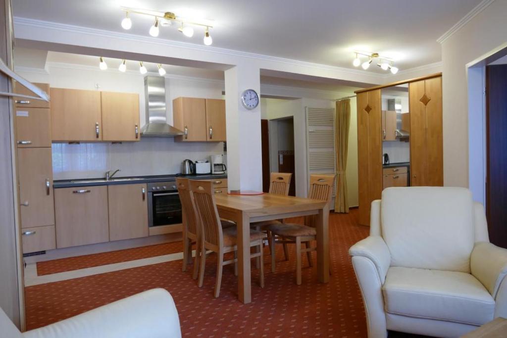 a kitchen and dining room with a table and chairs at Baltic Nr. 26 in Scharbeutz