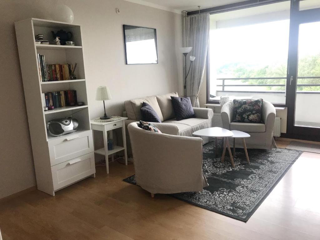 a living room with a couch and chairs and a table at Ferienwohnung StrandinSicht in Damp