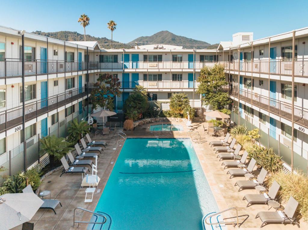 an aerial view of a hotel with a pool and lounge chairs at Marin Suites Hotel in Corte Madera