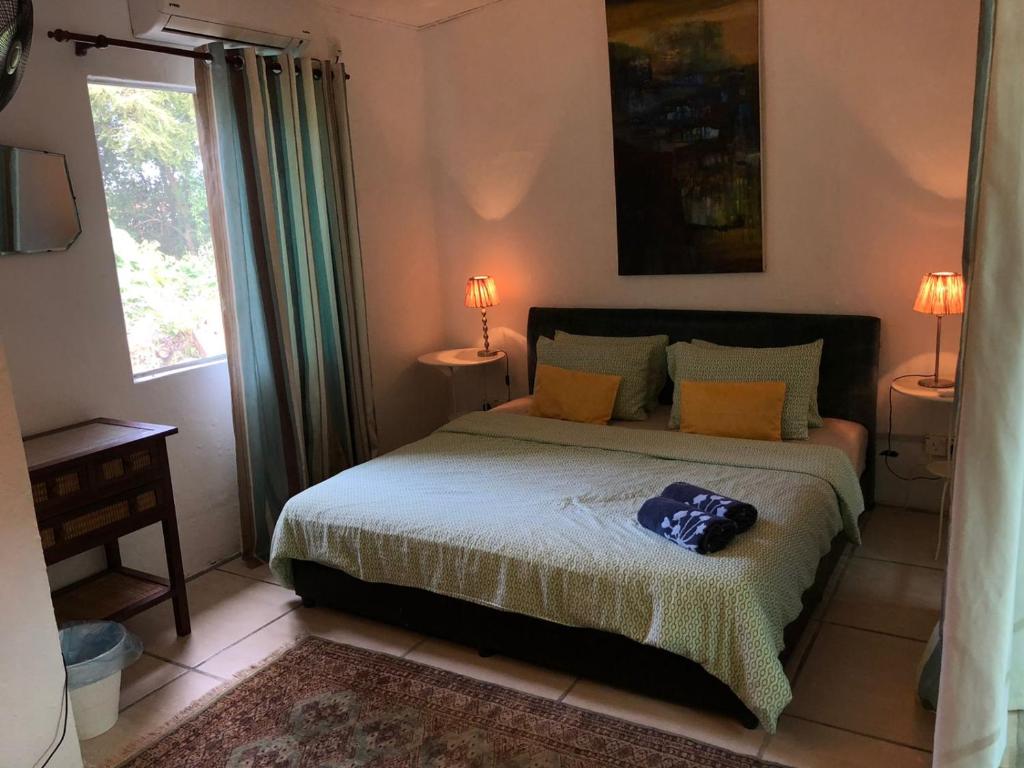 Postel nebo postele na pokoji v ubytování Pondok Keladi Langkawi Guesthouse
