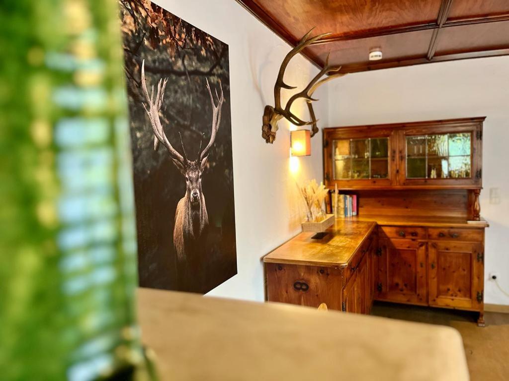 a room with a painting of a deer on the wall at Jägerlodge am Waldrand in Grainau in Grainau