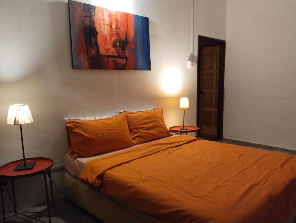 Postel nebo postele na pokoji v ubytování Pondok Keladi Langkawi Guesthouse