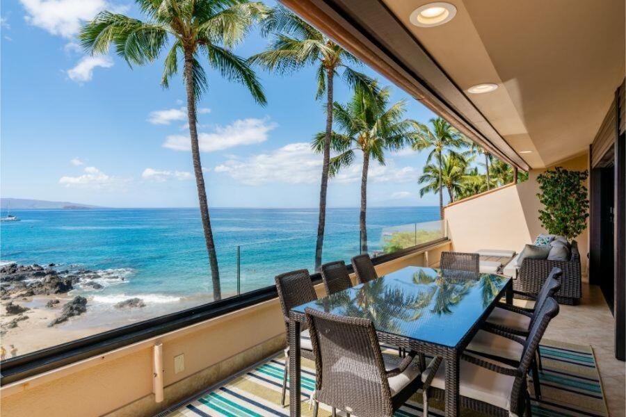 a dining room with a view of the ocean at MAKENA SURF, #G-301-302 condo in Wailea