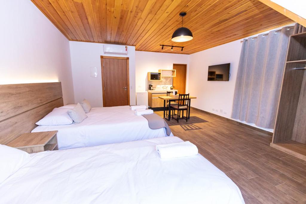 Postel nebo postele na pokoji v ubytování Chalés Estilo de Campos