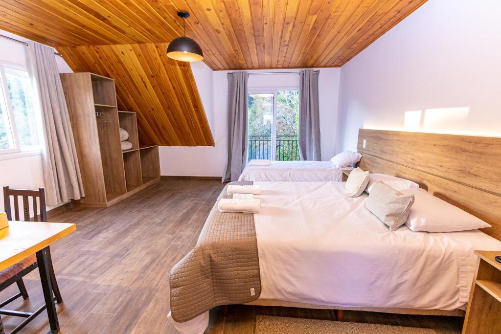 Postel nebo postele na pokoji v ubytování Chalés Estilo de Campos