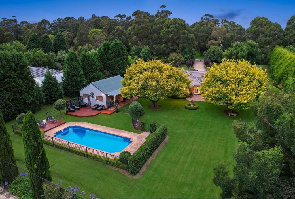 an aerial view of a home with a swimming pool in a yard at Avonlea, Bowral, Southern Highlands in Bowral