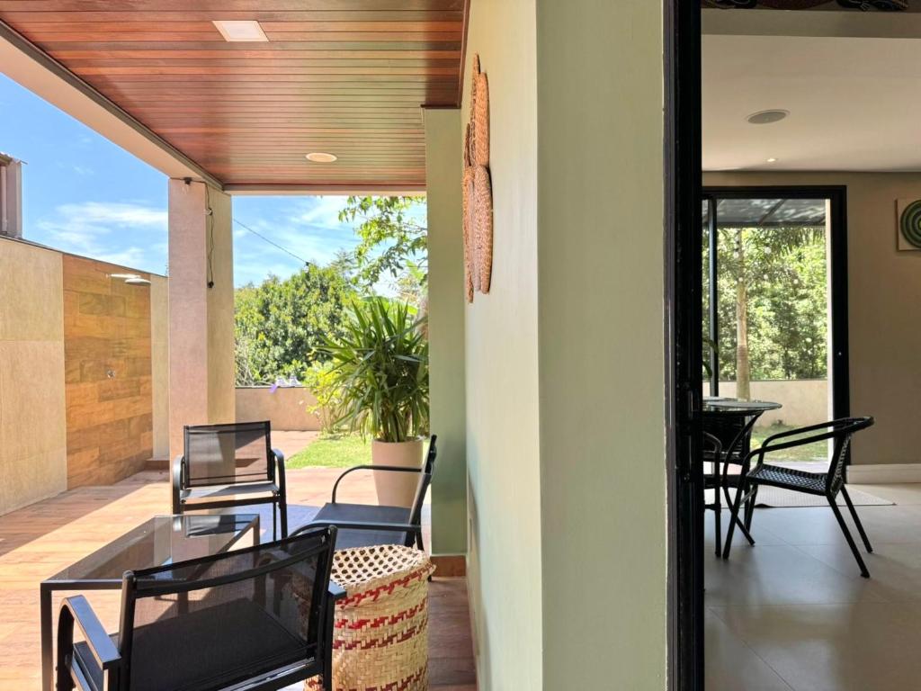 a living room with a glass table and chairs at OKA Praia Cabeçudas & SPA in Itajaí