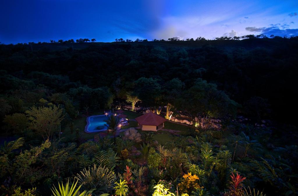 an aerial view of a house in the forest at night at Cabanas Rio Encantado in Alto Boquete
