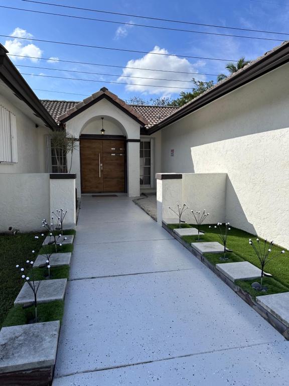 a driveway leading to a house with a garage at Hushed Miramar Town in Miramar