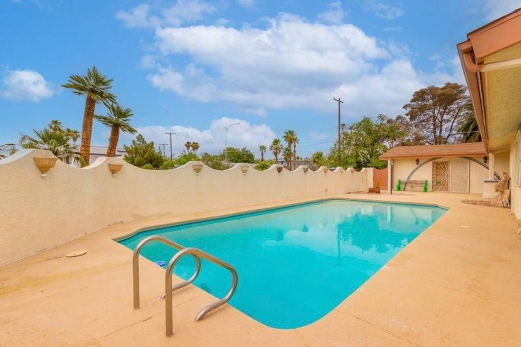 a swimming pool in front of a fence at Las Vegas Luxury House in Las Vegas