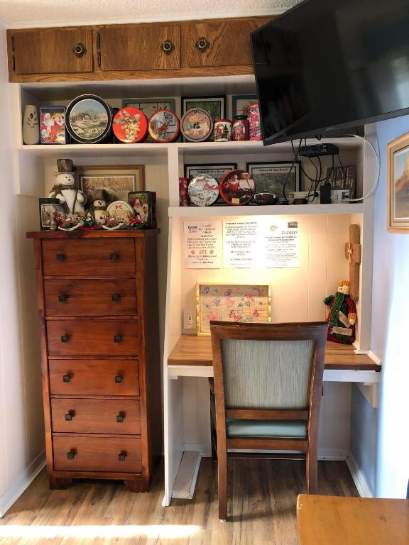 a room with a desk with a chair and a dresser at Fishers Of Men Ranch Home in Marble Falls