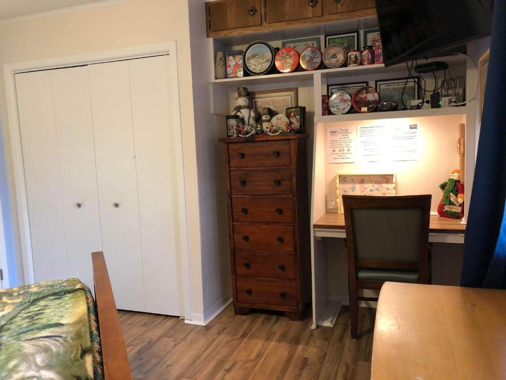 a room with a desk and a cabinet and a table at Fishers Of Men Ranch Home in Marble Falls