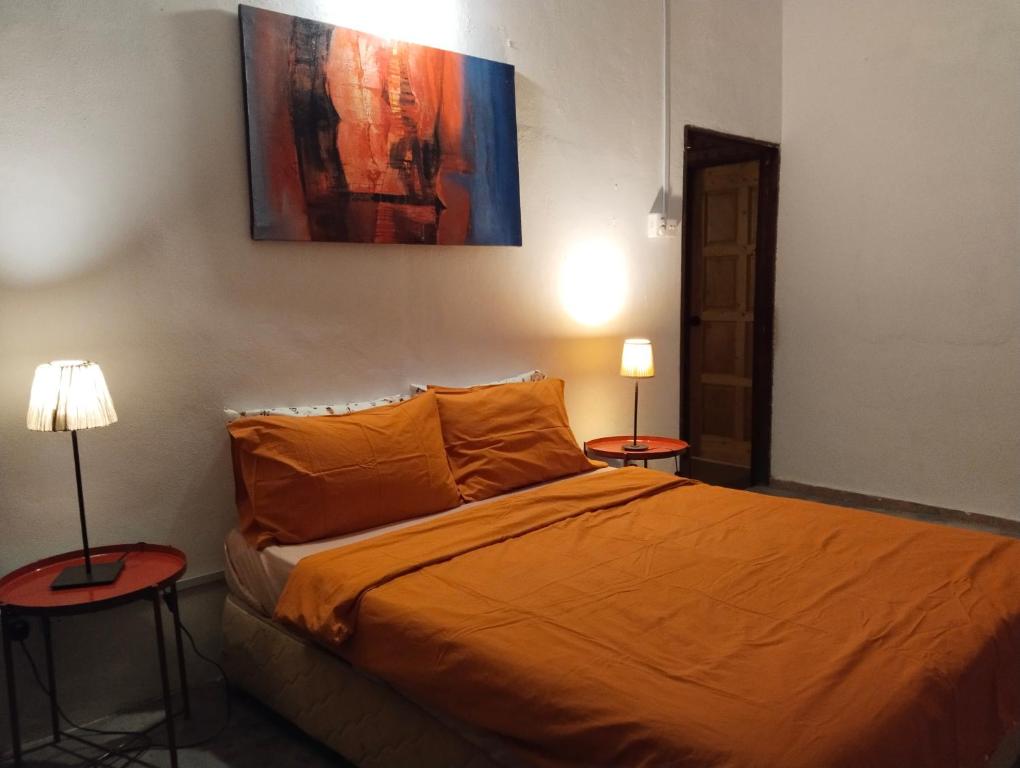 Postel nebo postele na pokoji v ubytování Pondok Keladi Langkawi Guesthouse