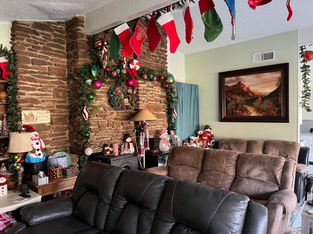 a living room with two leather couches and christmas decorations at Fishers Of Men Ranch Home in Marble Falls