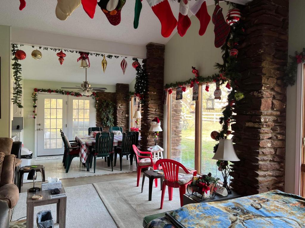 a living room with a table and chairs and christmas decorations at Fishers Of Men Ranch Home in Marble Falls