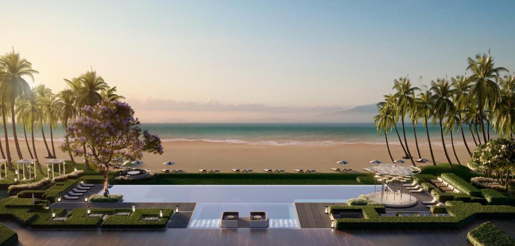 SematanにあるRoxy Beach Apartmentのプールとビーチのあるリゾートの景色を望めます。