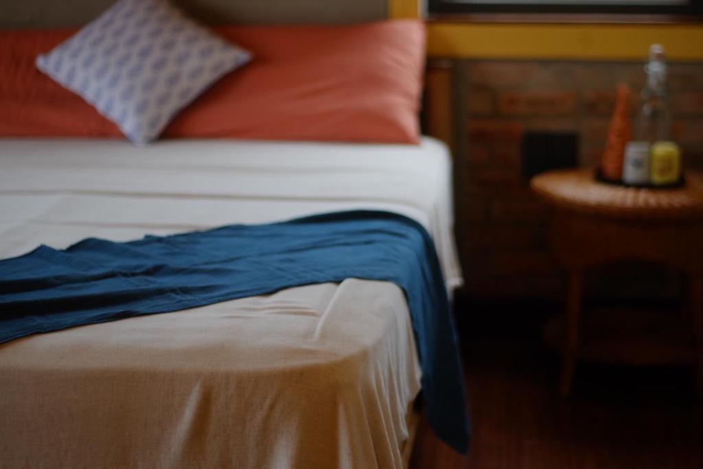 a close up of a bed with a blue blanket on it at Lagom Home in Hue