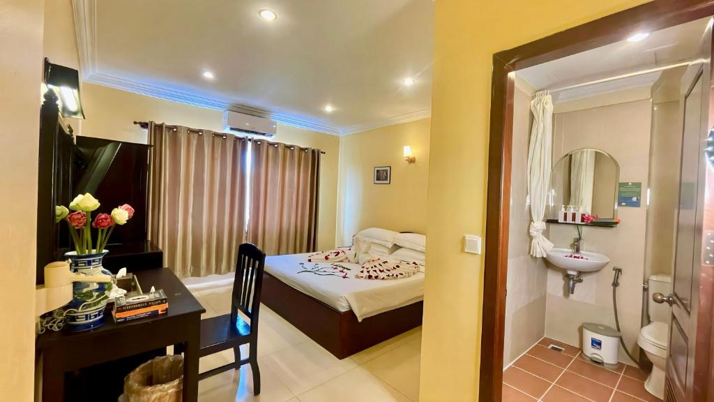 Postel nebo postele na pokoji v ubytování Harmony Indochine d'Angkor