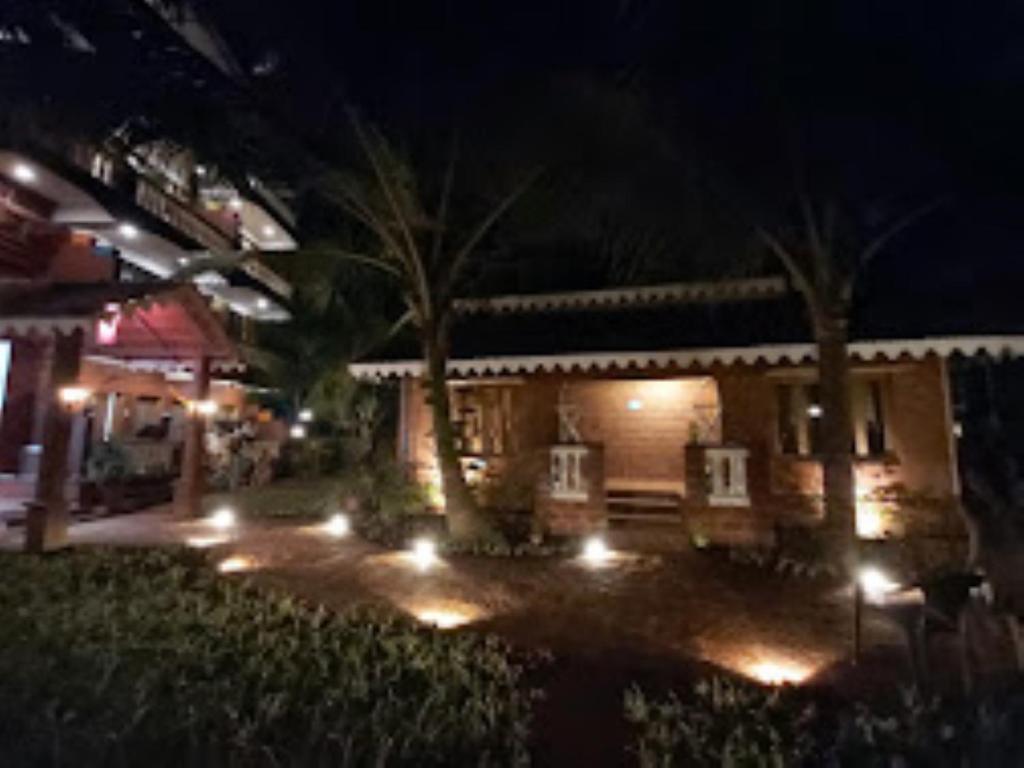 una casa con luci nel cortile di notte di Blue Sea Beach Resort Malvan a Malwan