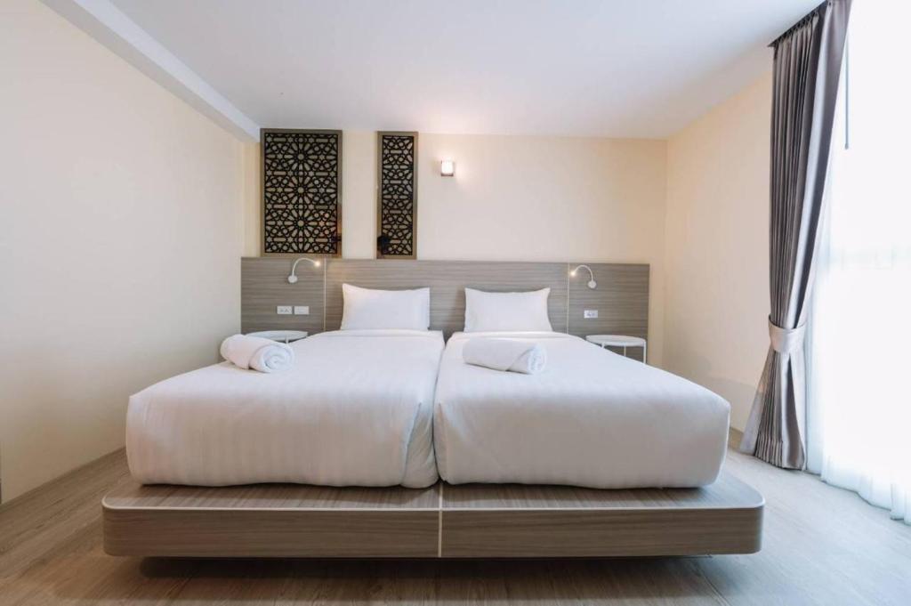 Postel nebo postele na pokoji v ubytování วัน บัดเจท เชียงราย พหลโยธิน One Budget Hotel Chiangrai Phahonyothin