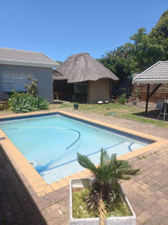 a swimming pool in front of a house at BnB Panorama in East London