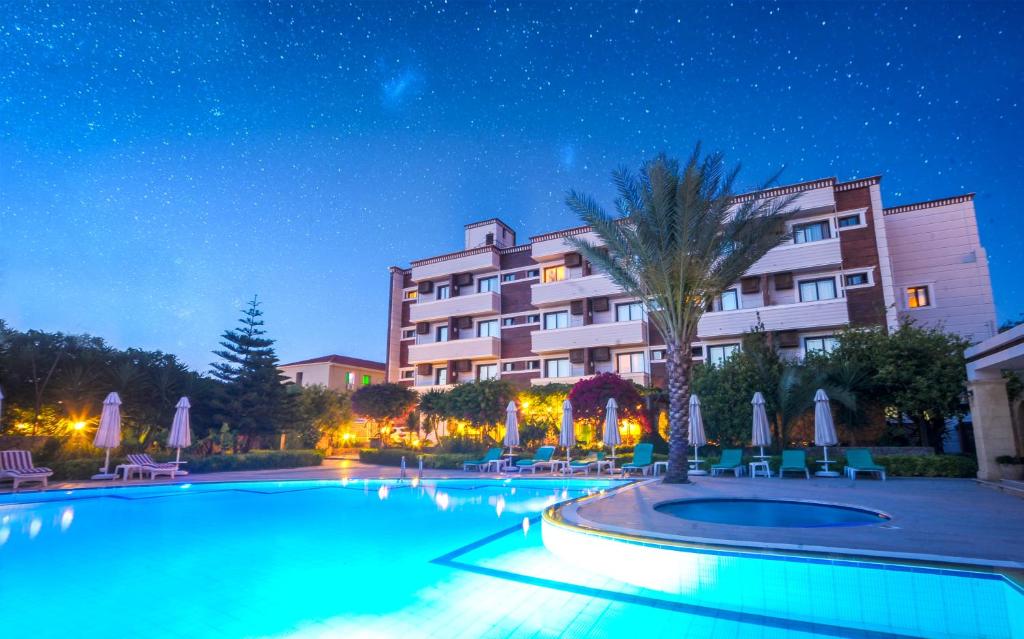 een zwembad voor een hotel 's nachts bij ANADOL Hotel & Pool next to Kyrenia Harbour in Kyrenia