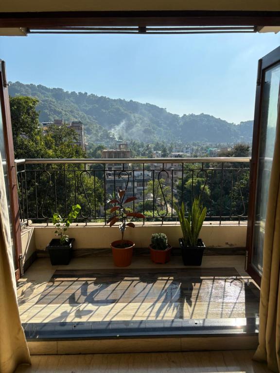 a balcony with a view of the mountains at Sushrita Hillview Homestay in Guwahati