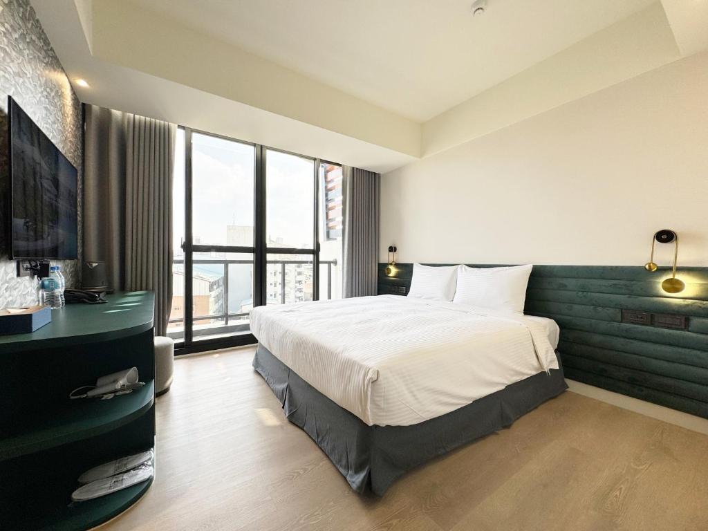 Ένα ή περισσότερα κρεβάτια σε δωμάτιο στο Joie de Inn