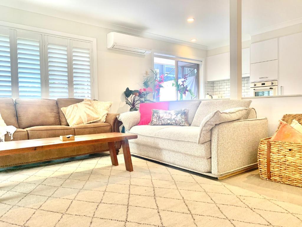 a living room with a couch and a coffee table at Byron Marvell in Byron Bay