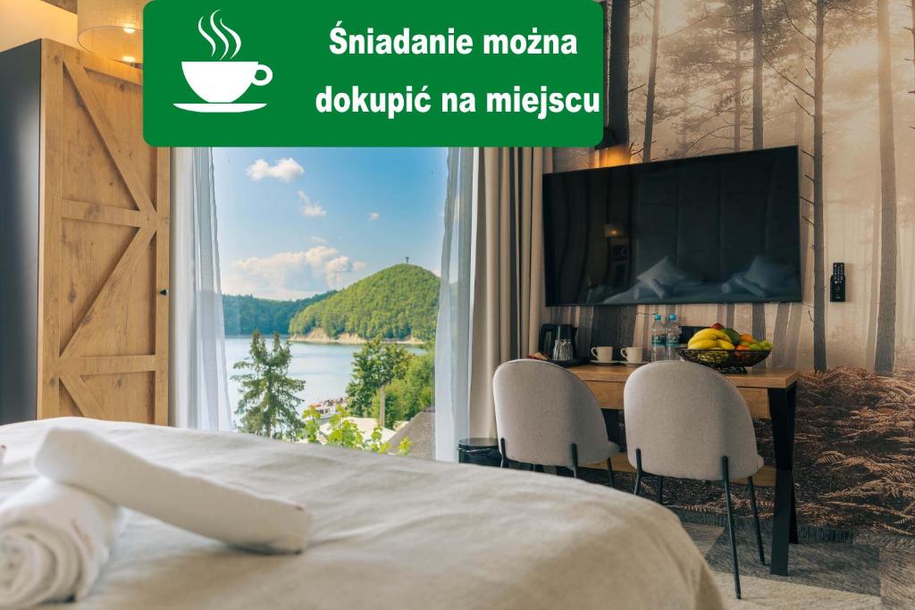 a bedroom with a bed and a window with a view at Sztygarka Hetmańska Resort Solina in Solina
