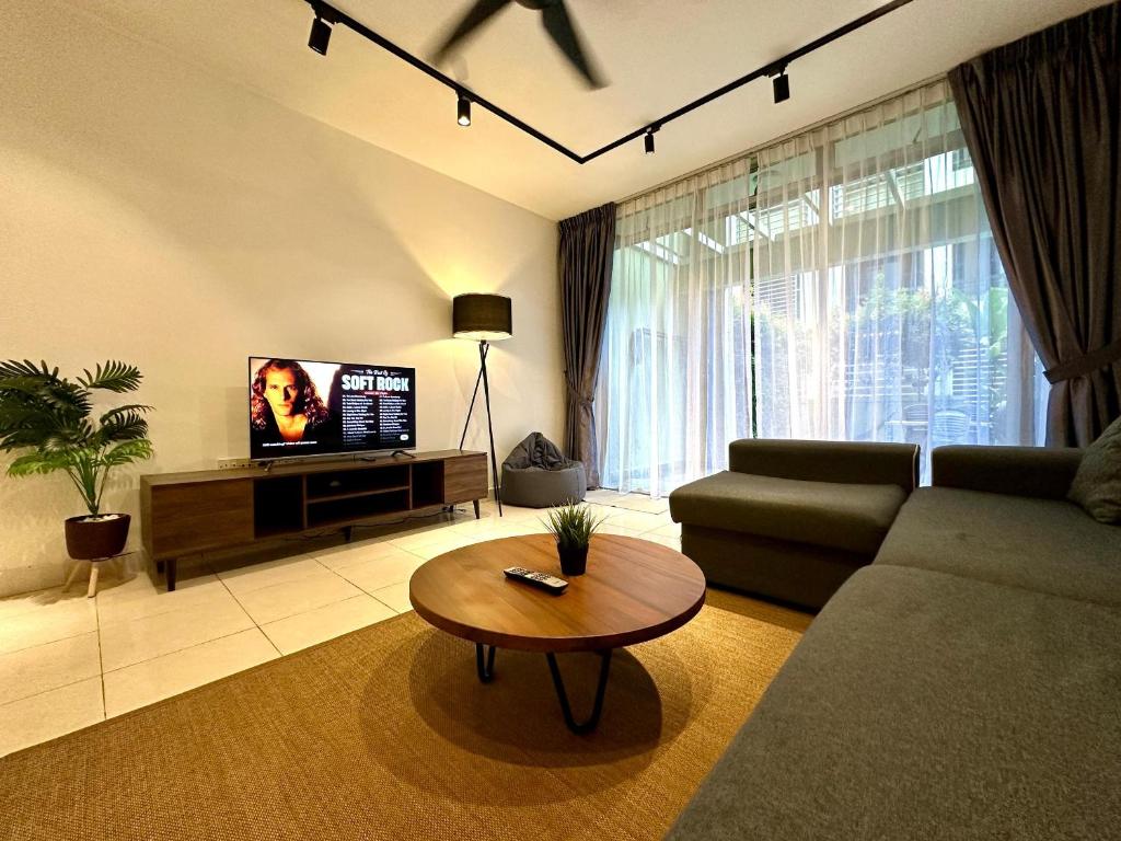 a living room with a couch and a coffee table at BNB Cozy Homestay @ Cyberjaya in Cyberjaya