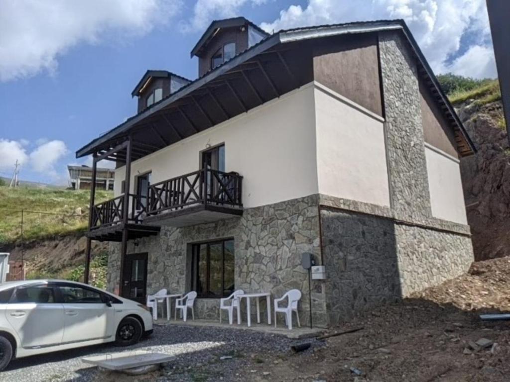 a house with a car parked in front of it at Khando2023 in Gudauri