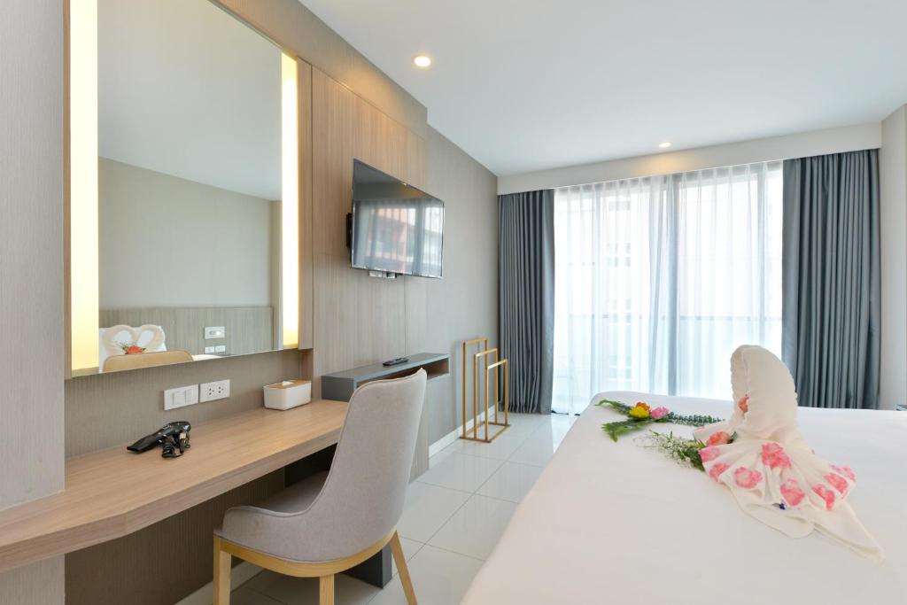 Postel nebo postele na pokoji v ubytování Grace Patong Hotel
