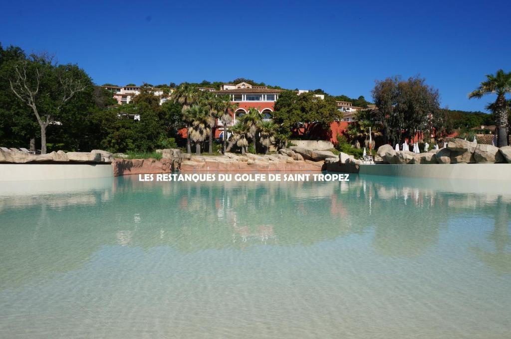 a large pool of water with a sign that reads us best emergency dip controller be at Les Restanques du Golfe de Saint Tropez in Grimaud