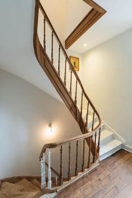 a staircase in a house with a wooden floor at Maison Comtale in Rochefort