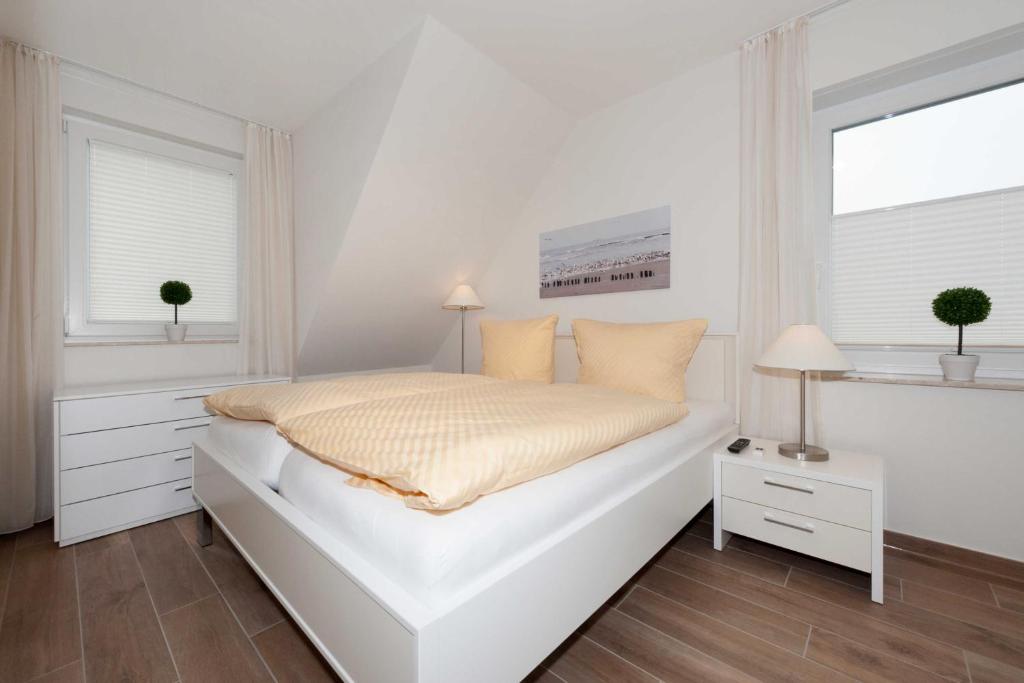 Postel nebo postele na pokoji v ubytování Ferienwohnung Inselstern - Residenz an der Nordseetherme
