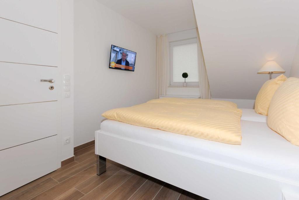 Postel nebo postele na pokoji v ubytování Ferienwohnung Inselstern - Residenz an der Nordseetherme