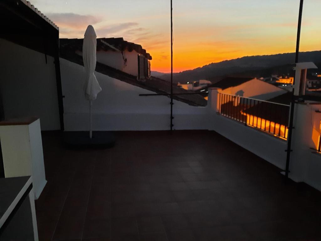 uma varanda com um pôr-do-sol ao fundo em CASA CHICA El Bosque em El Bosque