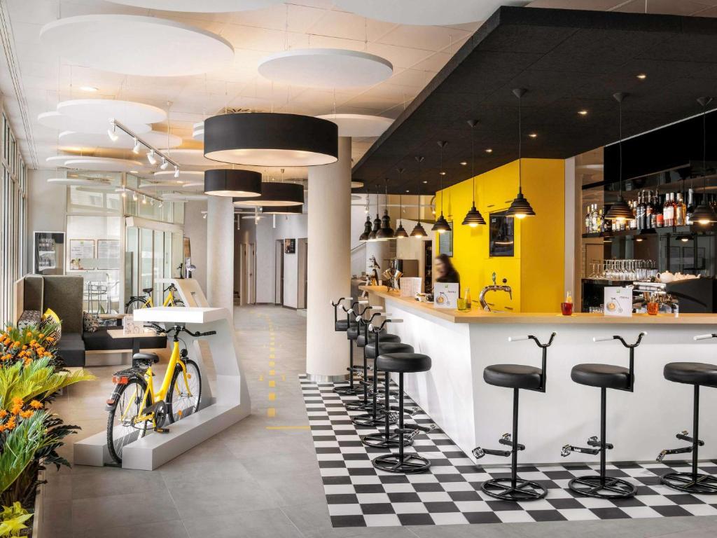 a bar in a restaurant with a bike on the counter at Ibis Styles Budapest City in Budapest