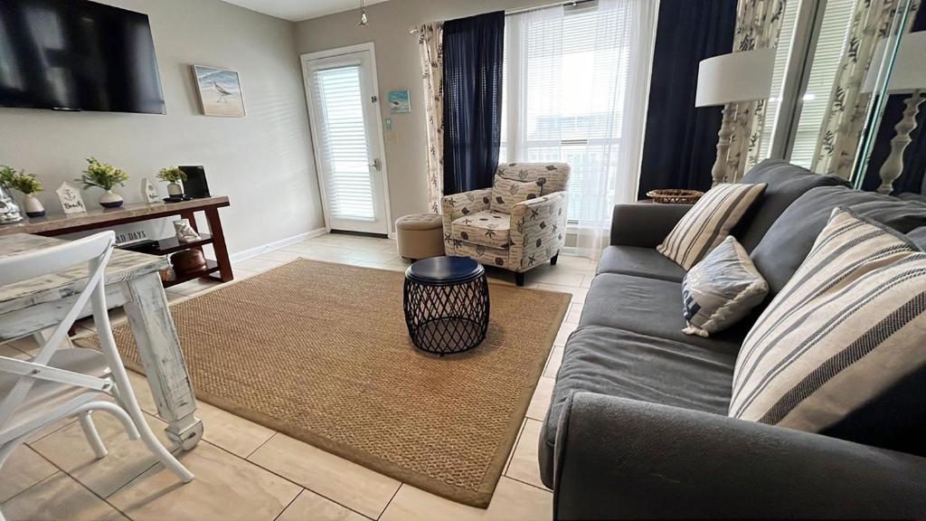 a living room with a gray couch and a table at Southwind I-9 in Panama City Beach