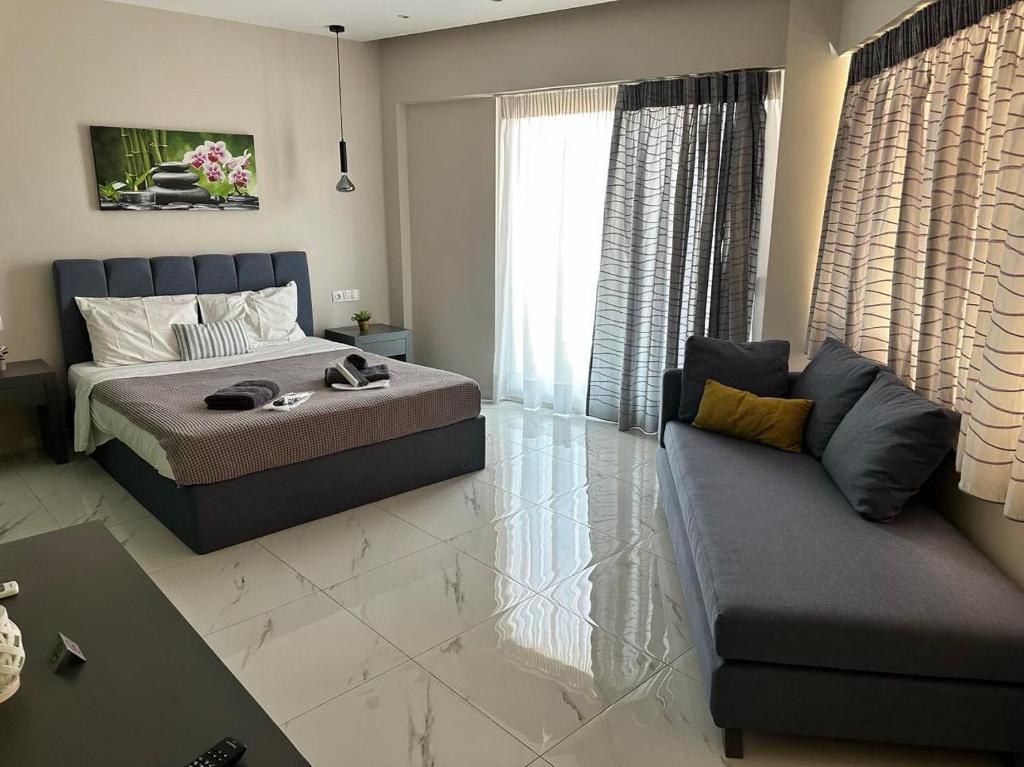 a living room with a bed and a couch at DAFNI LUXURY SUITES in Athens