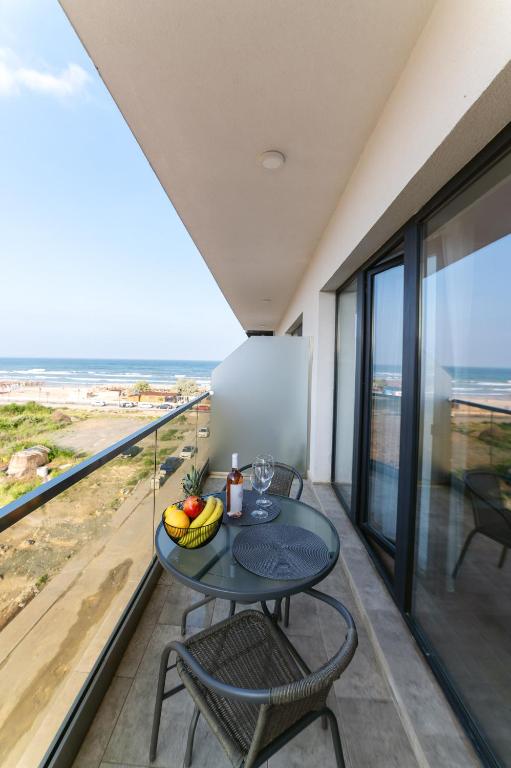 a table and chairs on a balcony with a view of the ocean at SOLMAR Studios in Năvodari