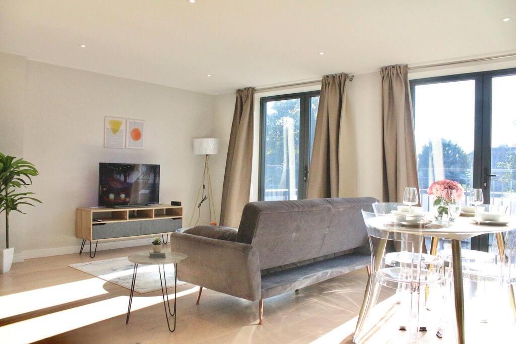 a living room with a couch and a television at Spacious 2BR Apartment with Terrance in London
