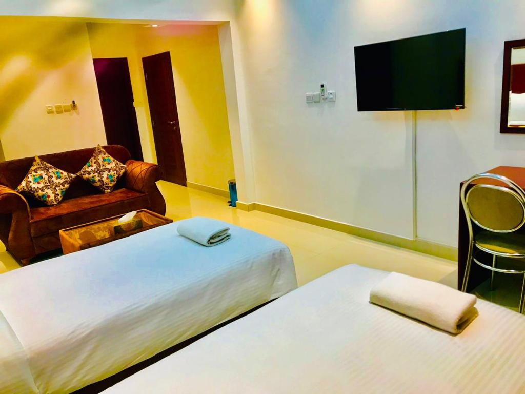 Postel nebo postele na pokoji v ubytování ALJAWHARA INN HOTEL